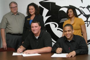 Clark football players sign letters C. Smith, J. Tilghman sign with parents